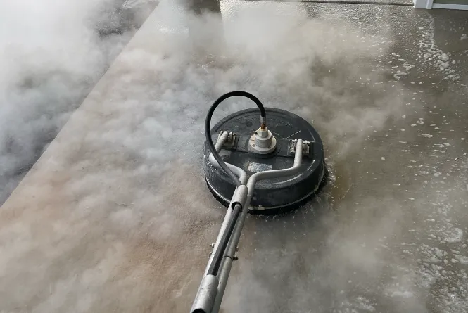 Rotary surface cleaner on a driveway in Winchester VA by Thompson's Pressure Washing